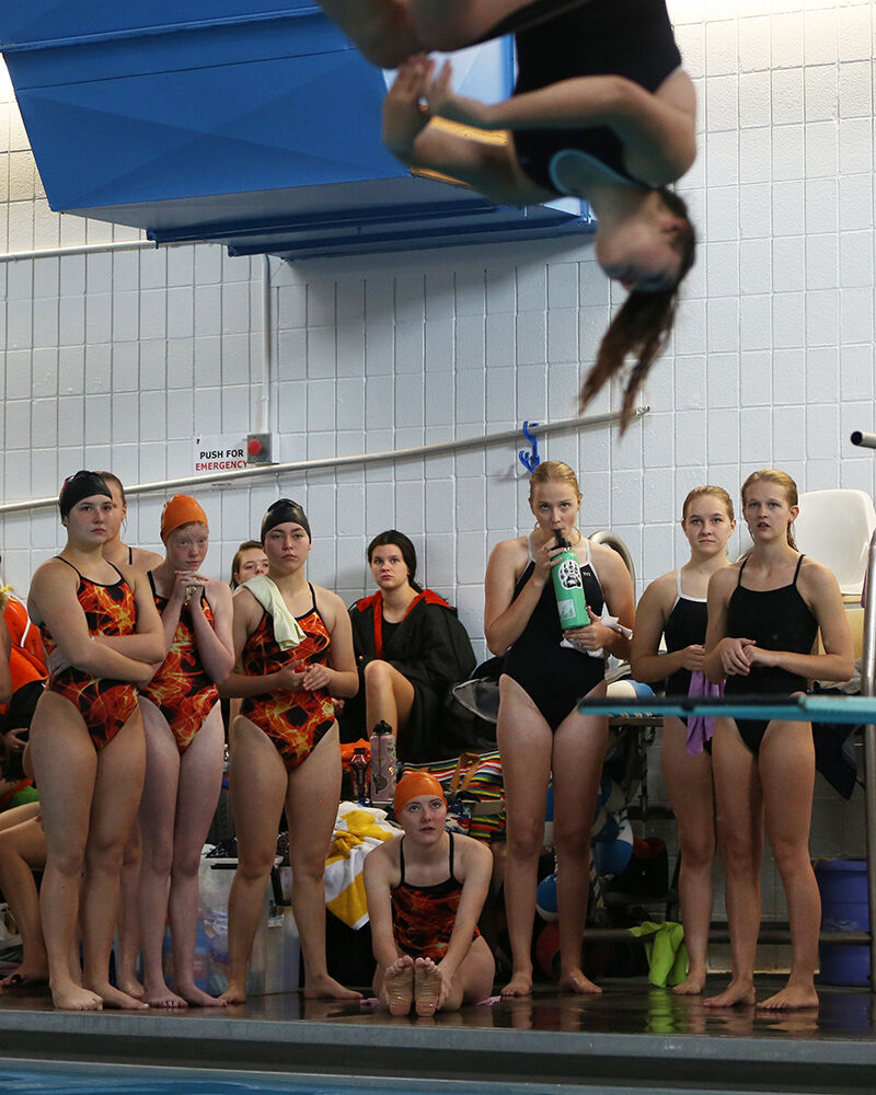 Olivia Maertens, right, joins the rest of the divers in watching a peer